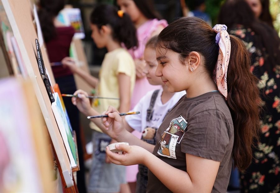 Children painting together in art class