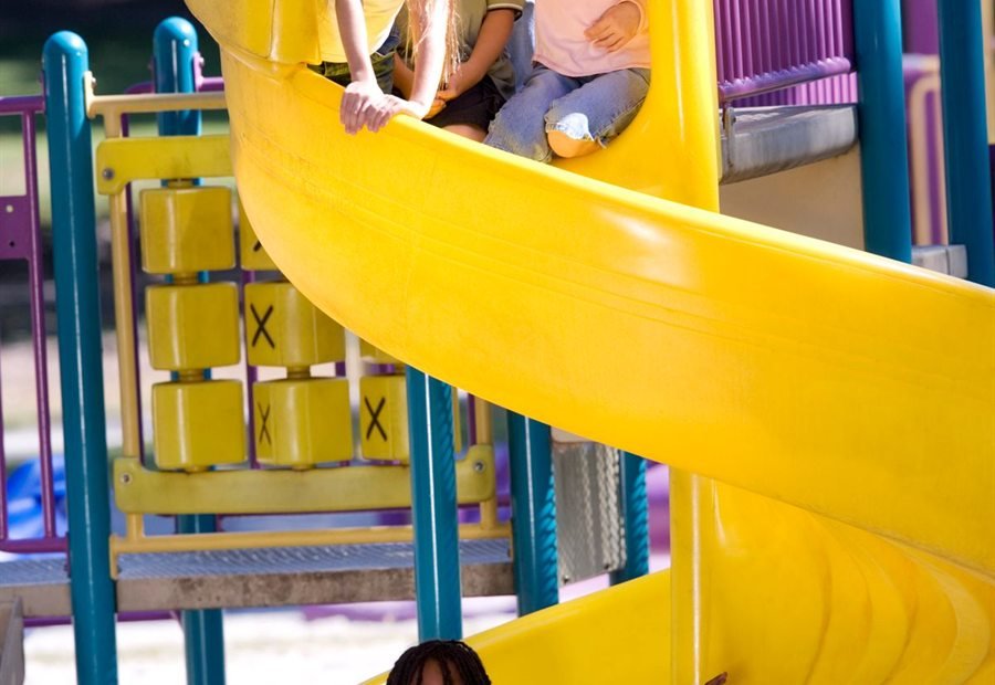 Children playing on the playground slide
